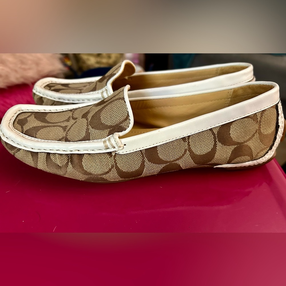 Classic brown, white, and tan Coach loafers.